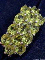 Top view showing peridot cluster arrangement on silver setting