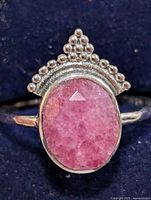 Front view of sterling silver ring with oval ruby cabochon and beaded crown accent
