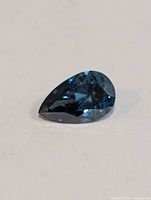 Pear-cut blue lab grown diamond on neutral background