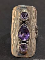 Front view showing hammered rectangular face and three amethyst stones