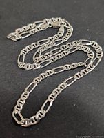 Full view of silver figaro chain