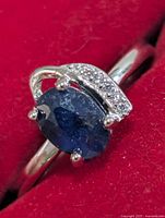 top view silver ring with oval blue sapphire and accent stones