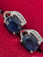 front view showing sapphires and accent stones on red background