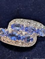top view showing six oval tanzanite stones and accent stones