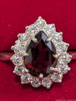 Front view pear garnet ring with CZ halo