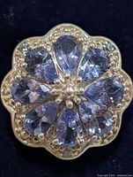 Top view showing flower cluster of pear-cut tanzanite stones in silver setting