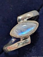 Front view of silver ring showing marquise moonstone cabochon