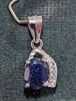 Front view of pendant showing sapphire and accent stones