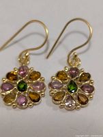 front view of both dangle earrings showing multicolour tourmaline stones and hooks