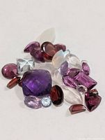 Close-up of assorted loose gemstones showing colours and cuts