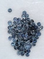 Close view of loose blue sapphires showing quantity and cut