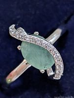 Front view showing oval green stone and CZ swirl