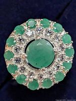 Top view showing central green stone and surrounding halo