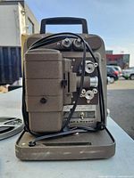 Front view of Bell & Howell 253A projector with power cord wrapped
