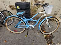 Right side view of blue and white Supercycle cruiser bicycle showing overall condition and components
