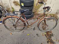 Left side view of entire bicycle showing frame style, drivetrain, wheels, fenders and rack