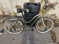 Left side view of bicycle showing frame, wheels, pedals, rack
