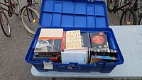 Open bin showing assorted books with visible titles
