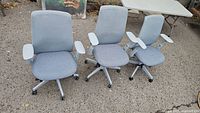 Front view of three Haworth chairs demonstrating frame color, seat fabric and caster bases