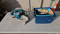Makita compound miter saw on table with tote containing circular saw