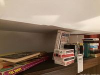 Wide view of shelf showing multiple playing card decks and purple tarot box