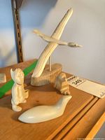 Group shot of all four carvings on shelf