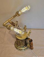 Front view of brass burner lamp with two lit spiral LED bulbs