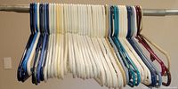 Row of assorted plastic hangers on rail