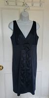 Front view of Calvin Klein black sheath dress on hanger