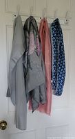 Four scarves hanging showing colors and patterns