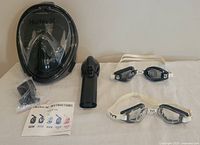 Overall lot with mask, snorkel tube, goggles, accessories, manual