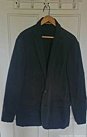 Front view of navy blazer on hanger