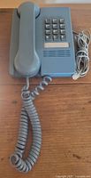 Top view of Northern Telecom push-button desk phone with handset, keypad, cords visible