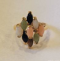 Front view of ring showing gold band and nine marquise stones