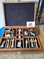 Open wood case showing all pewter Nativity figures in compartments