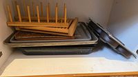 Stack of roasting pan, multiple baking sheets, muffin pan and bamboo rack