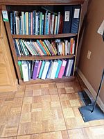 Front view of bookcase with three shelves and contents (not included)