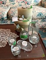 All candles and holders arranged on table