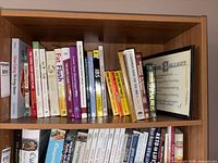 Shelf with assorted health, diet, grammar books and framed certificate