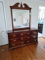 Front view showing dresser, all drawers, and attached mirror
