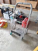 Front angled view showing steel wire basket, foam handle, wheels and folding mechanism