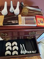 Overall view showing fondue fork box, soup spoons, chopsticks, spoon rests and ladle