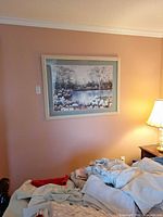 Framed print over bed showing full artwork and frame