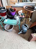 Overall lot showing kneeler, watering can, pots, stands