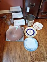 Assorted plates, glass trifle bowl, metal ice bucket, copper chargers, silver tray