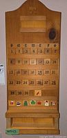 Full view of wooden wall calendar with date and holiday tiles inserted