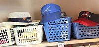 Shelf view of straw hat, visors in baskets