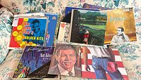 Stack of assorted LP covers including Nat King Cole, Perry Como, Bruce Springsteen, Scottish folk album