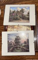 Front view showing matted landscape prints over round religious print and packaged shadowbox