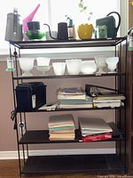 Front view of metal shelving unit showing four shelves and overall design